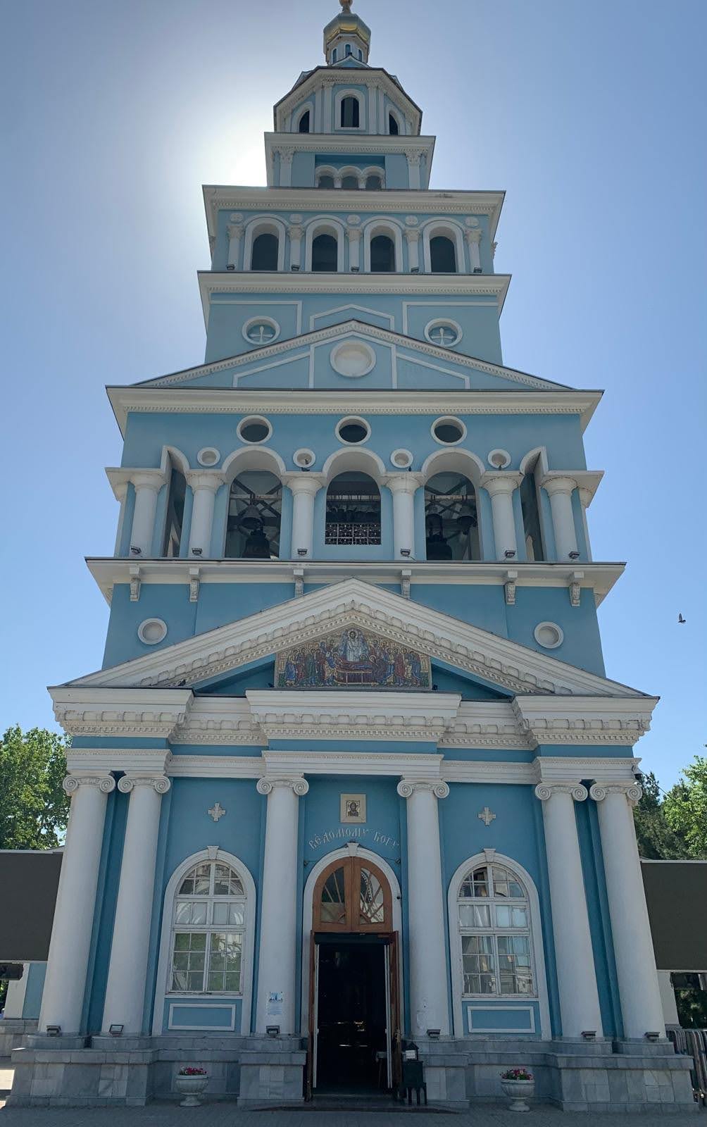 Historic Blue Church with Golden Dome A striking neoclassical church featuring a distinctive light blue façade with white Corinthian