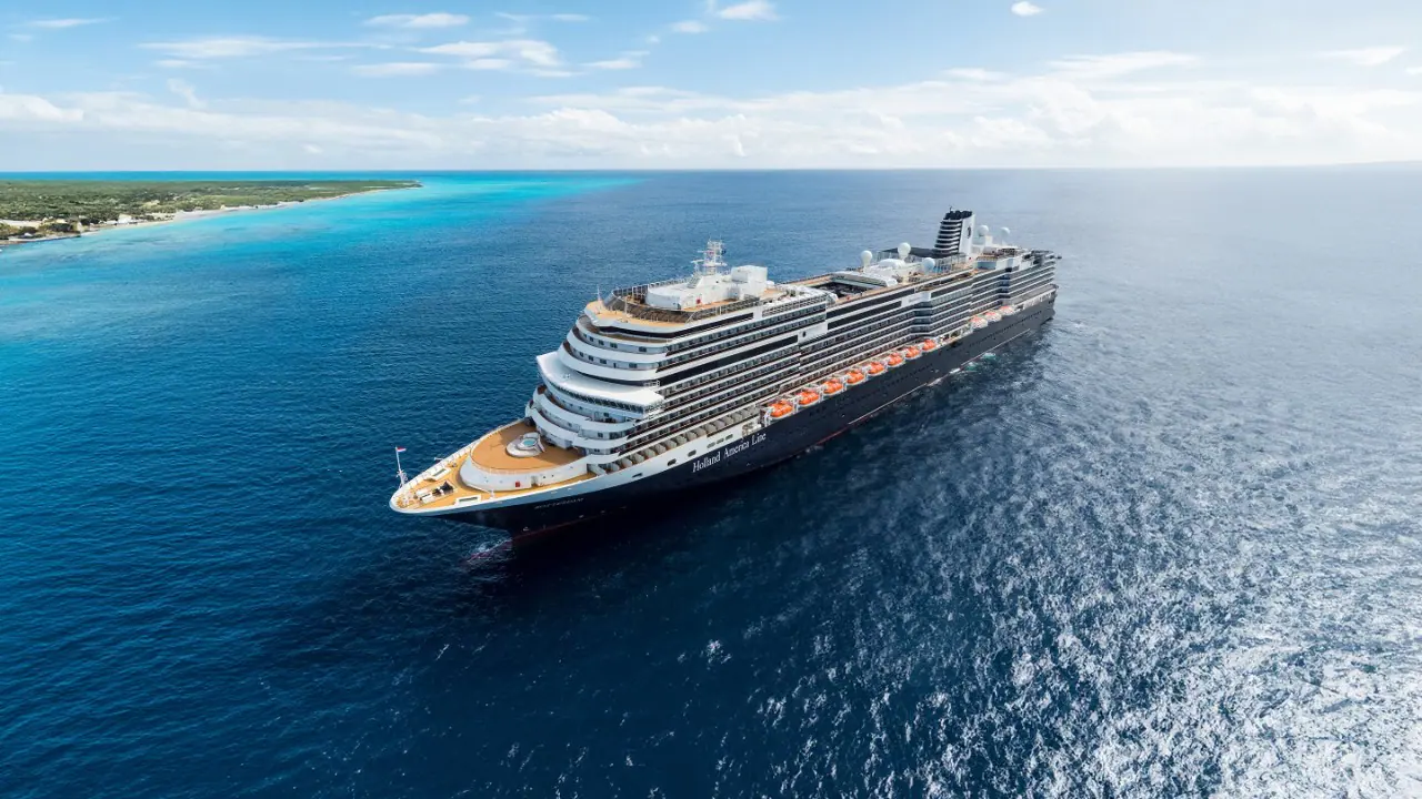 A striking aerial view of the Nieuw Statendam, a Holland America Line cruise ship, anchored