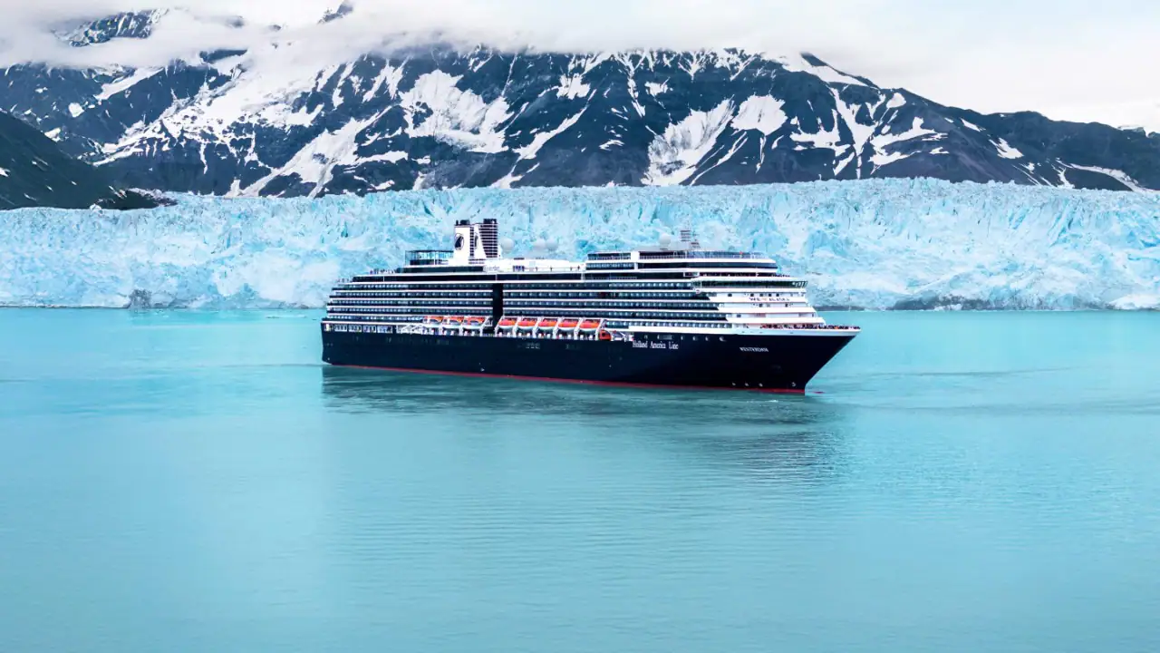A luxurious Holland America Line cruise ship, the Westerdam, sails through pristine turquoise