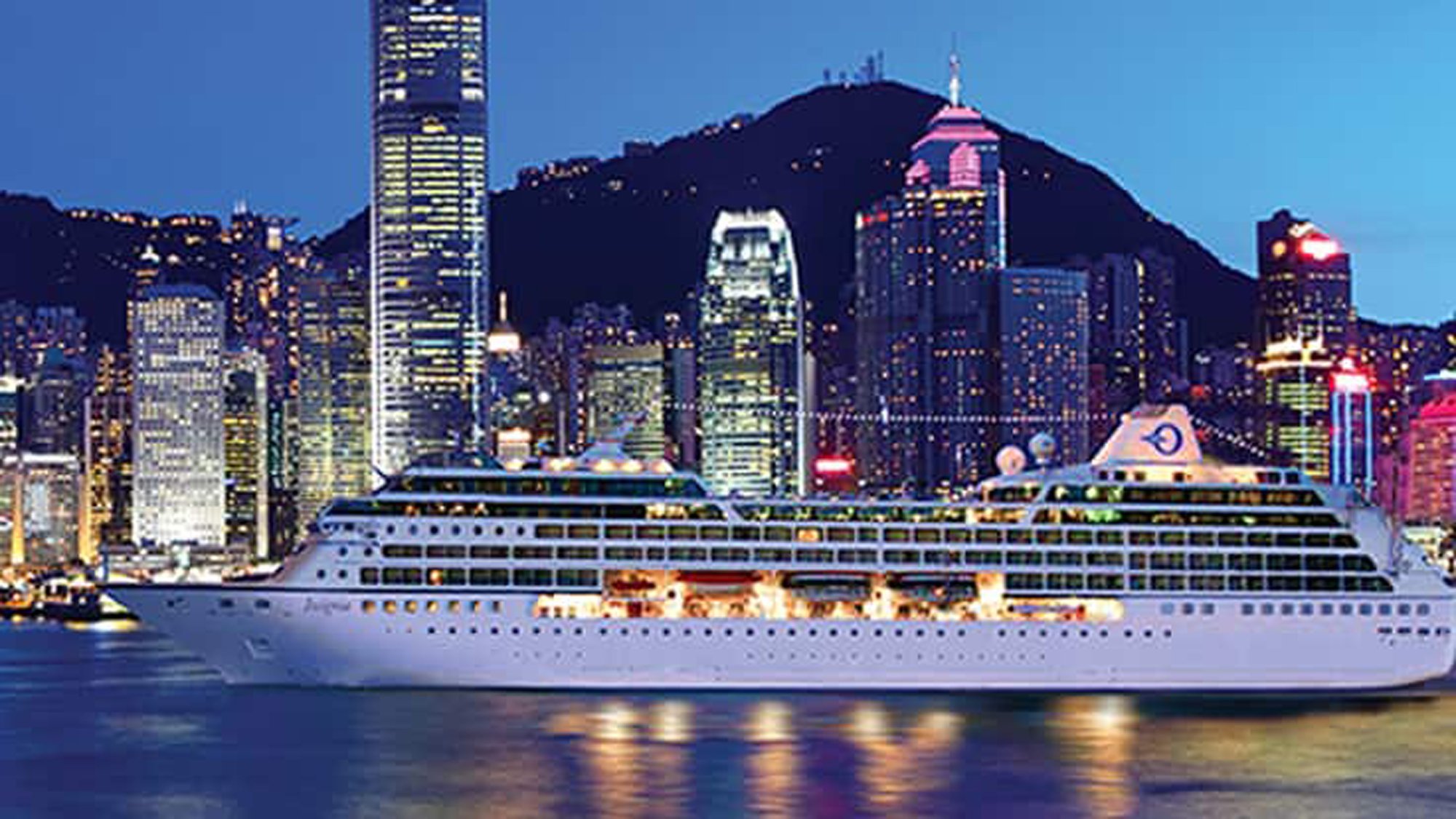 Insignia Cruise Ship in Hong Kong Harbor A luxurious cruise ship docked in Victoria Harbor, Hong Kong, with the illuminated skyline