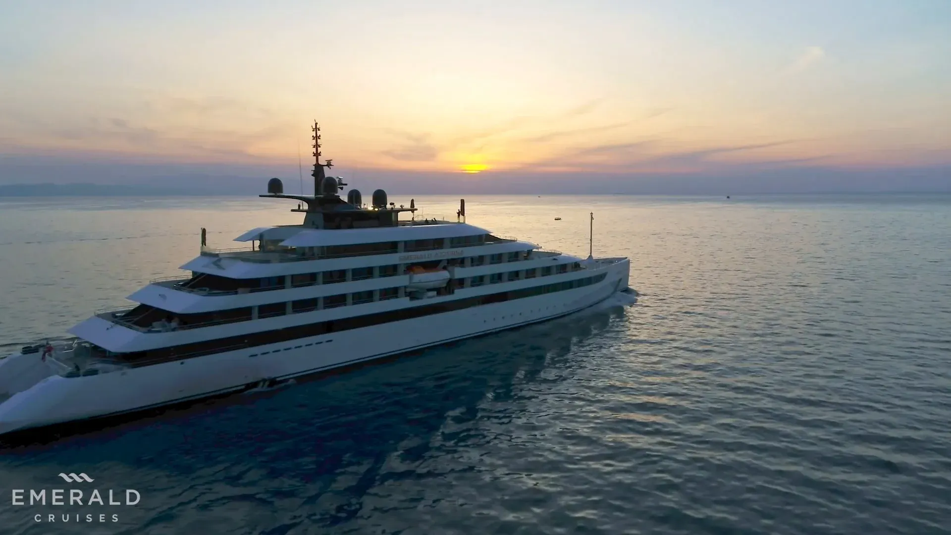 Luxury Expedition Yacht at Sunset A magnificent luxury expedition yacht with multiple decks anchored in calm turquoise waters during