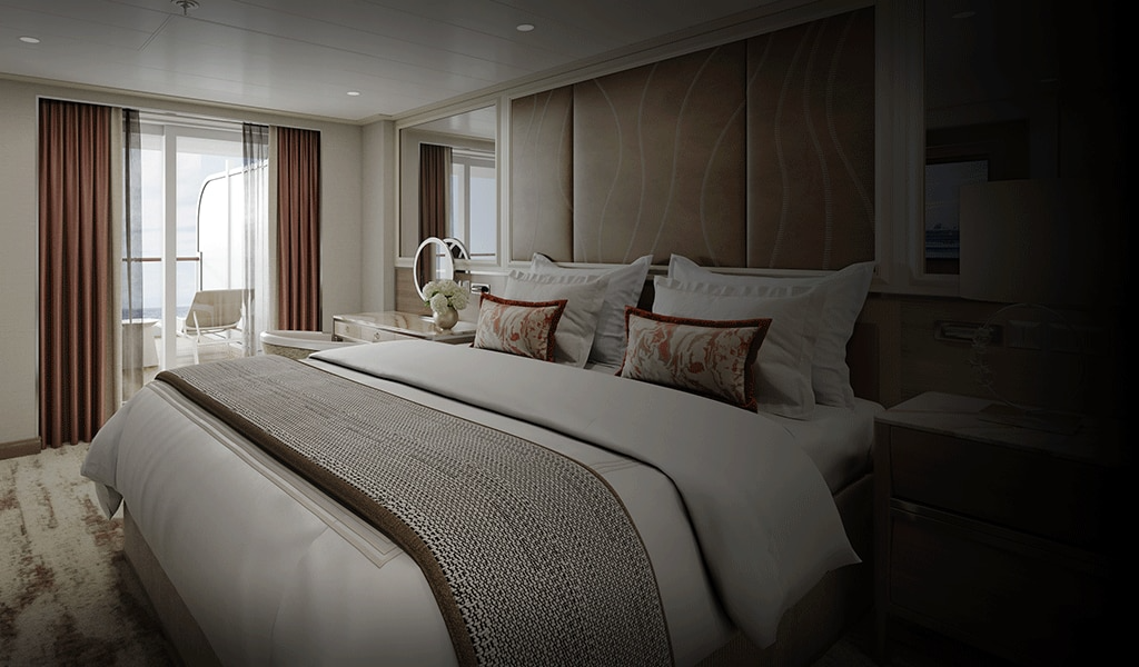 Luxury Suite Aboard Regent Seven Seas Prestige An elegantly appointed master suite featuring a king-size bed with premium linens, decorative throw
