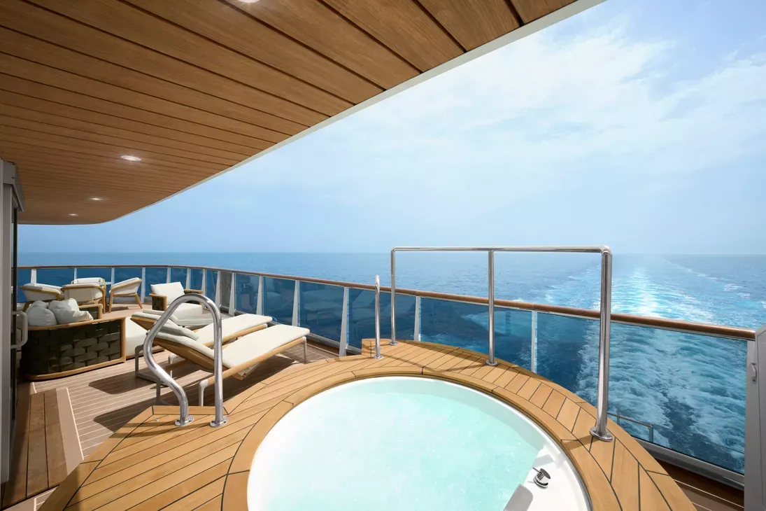 Luxury Suite Balcony with Hot Tub and Ocean View An expansive private balcony aboard a luxury cruise ship featuring a circular hot tub