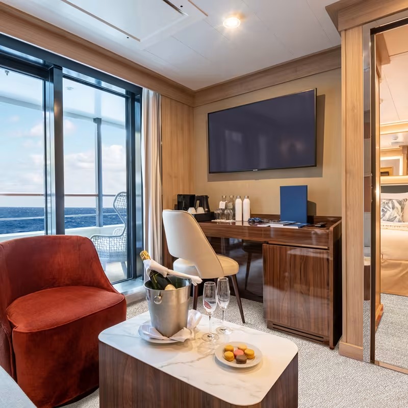 Luxury Suite with Ocean View Aboard Expedition Vessel An elegantly appointed owner's suite featuring panoramic ocean views through floor-to-ceiling