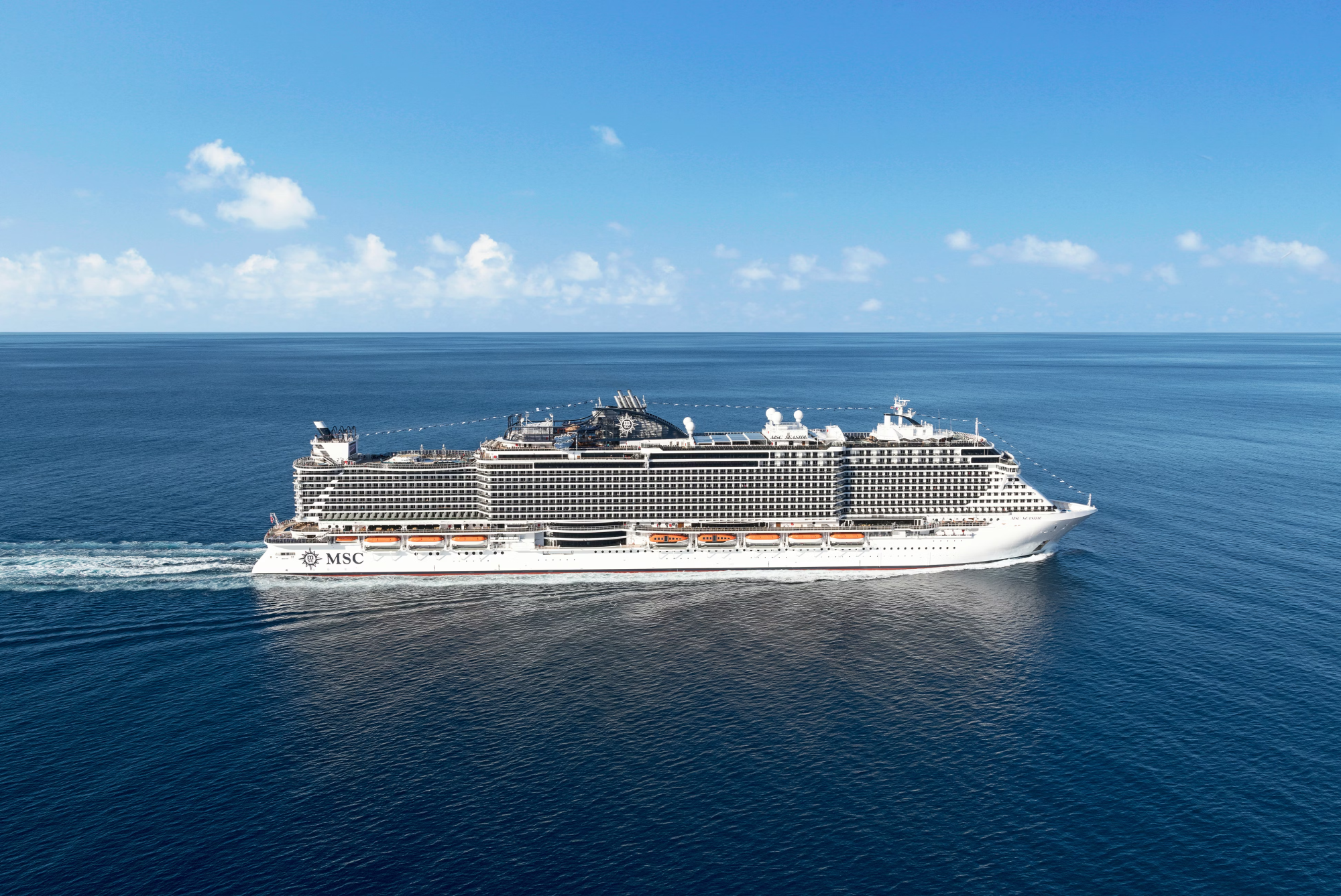 MSC Cruises Modern Mega-Ship at Sea A large modern cruise ship operated by MSC Cruises sailing through calm blue ocean waters under