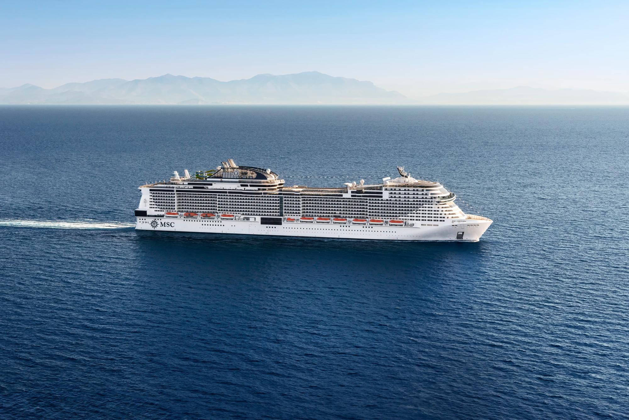 MSC Meraviglia Cruise Ship at Sea A modern large cruise ship operated by MSC Cruises sails through calm Mediterranean waters