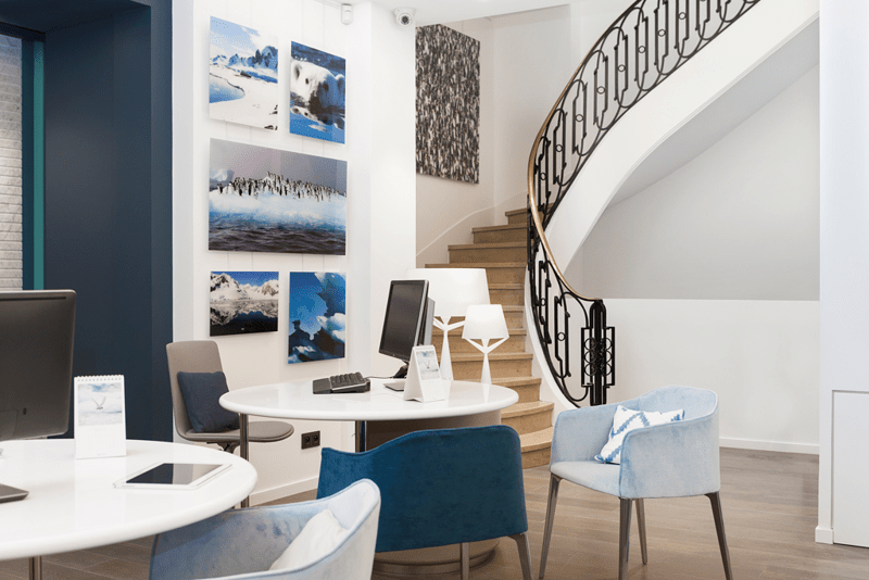 Modern Office Space with Arctic Photography A contemporary office interior featuring a curved staircase, modern furnishings, and a curated