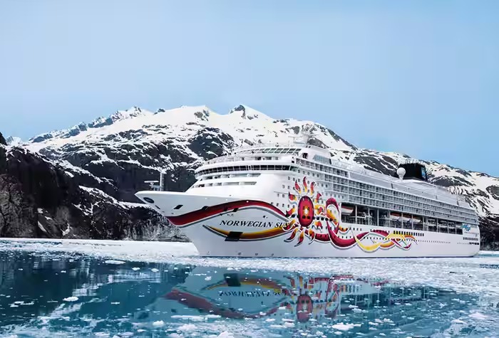 Norwegian Sky Cruise Ship in Arctic Waters The Norwegian Sky cruise ship navigates through icy Arctic waters with snow-capped mountains in