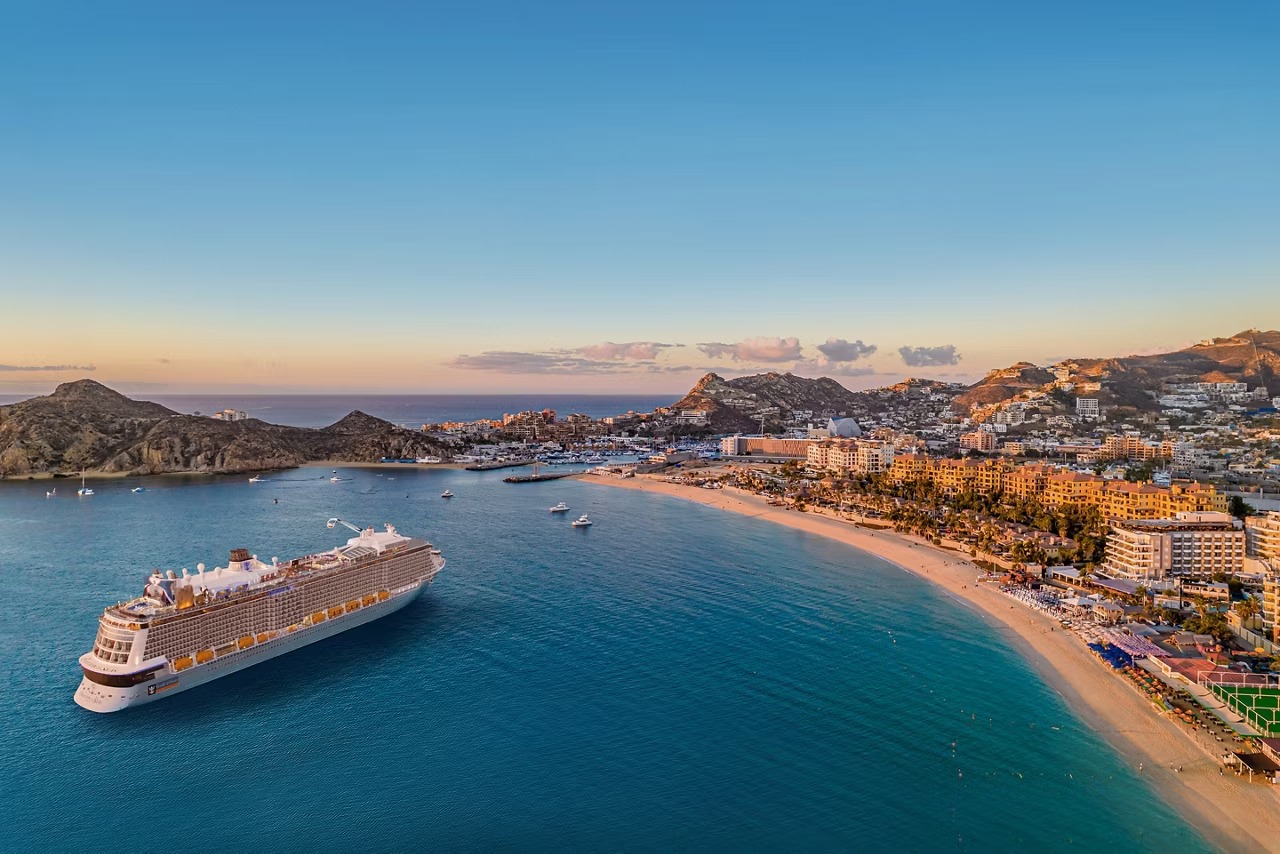 Ovation of the Seas at Cabo San Lucas Beach An aerial view of Royal Caribbean's Ovation of the Seas cruise ship anchored in the turquoise
