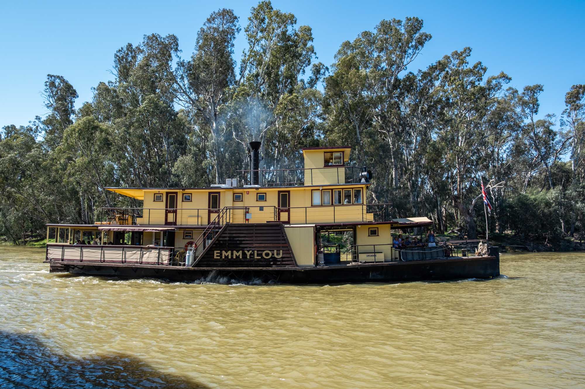 Paddle Steamer Emmylou on Murray River The authentic paddle steamer Emmylou, a yellow and black historic riverboat, operates on the Murray