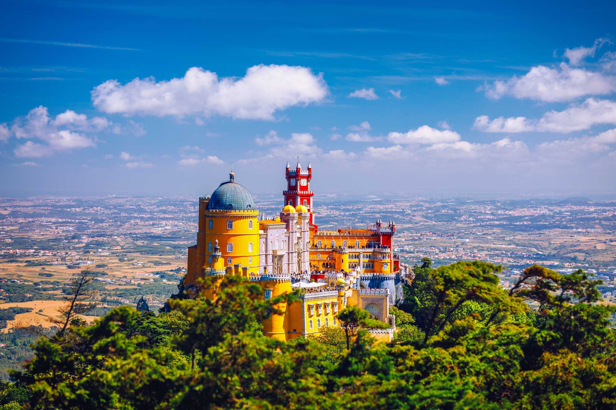 Pena Palace in Sintra, Portugal A stunning aerial view of the iconic Pena National Palace perched on a hilltop in Sintra, Portugal