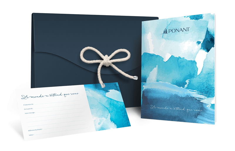 Ponant Gift Set with Watercolor Design An elegant luxury gift package from Ponant cruise line featuring a dark navy envelope with natural