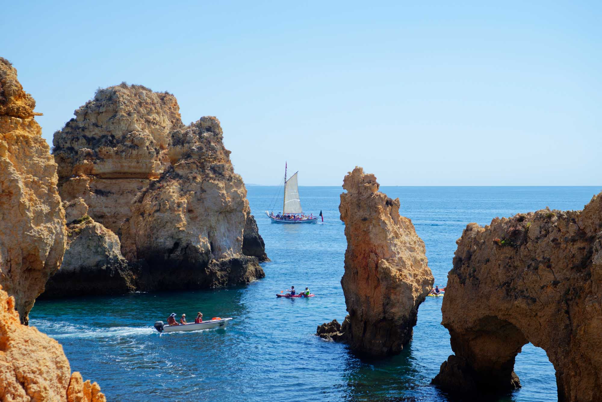 Ponta da Piedade Boats and Golden Rock Formations A stunning coastal scene at Ponta da Piedade in Portugal's Algarve region, featuring golden