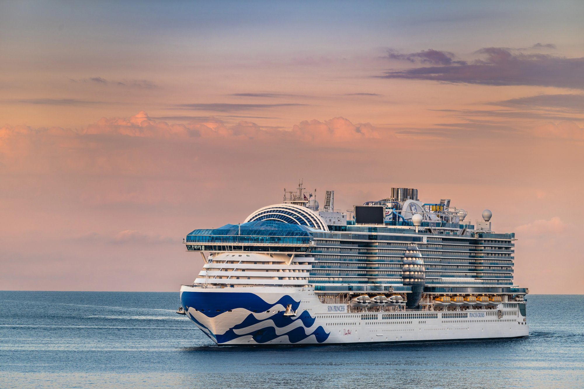 Princess Cruises Ship at Sunrise in Montenegro A large modern cruise ship featuring Princess Cruises' distinctive blue and white hull design sails