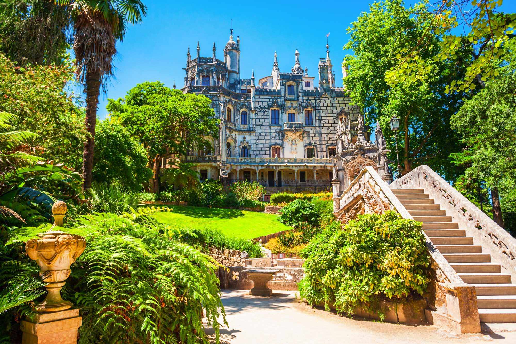 Quinta da Regaleira Palace in Sintra, Portugal A stunning view of the ornate Quinta da Regaleira Palace nestled among lush green gardens