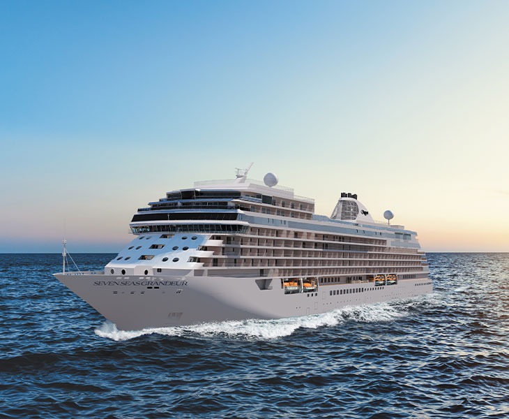 A luxurious modern cruise ship, the Regent Seven Seas Grandeur, captured at sea during golden hour