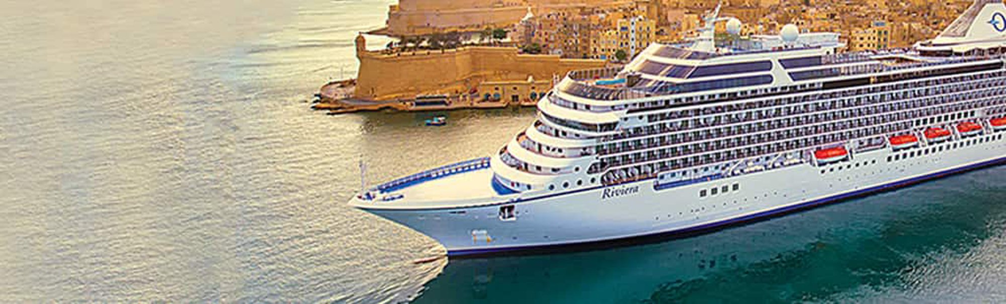 Riviera Cruise Ship Docked in Malta A large modern cruise ship named Riviera is moored in the harbor of Valletta, Malta, with