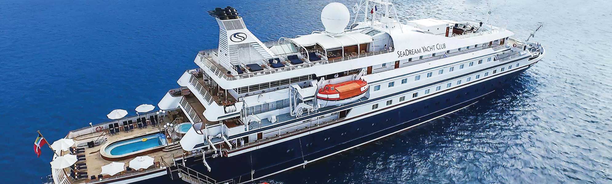 SeaDream Yacht Club Luxury Cruise Ship An aerial view of the SeaDream Yacht Club expedition cruise vessel anchored in clear blue waters
