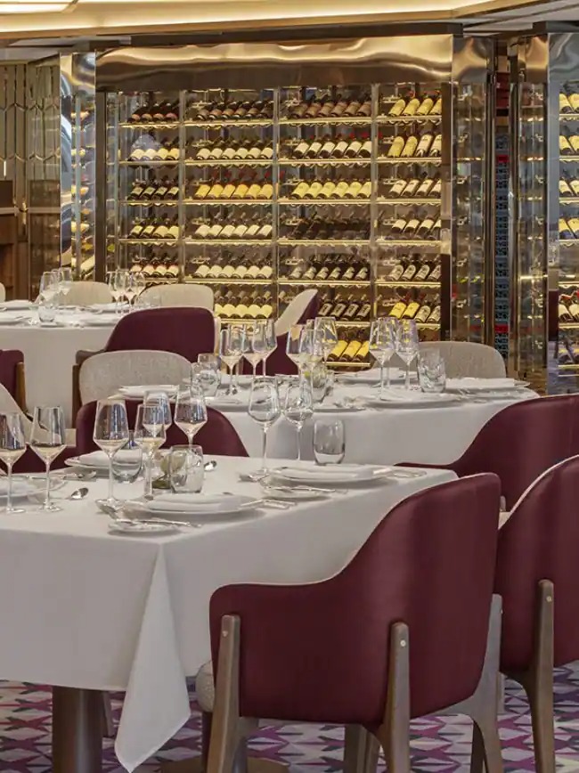 Seabourn Venture Fine Dining Restaurant with Wine Cellar An elegant fine dining restaurant aboard the Seabourn Venture, featuring formally set tables