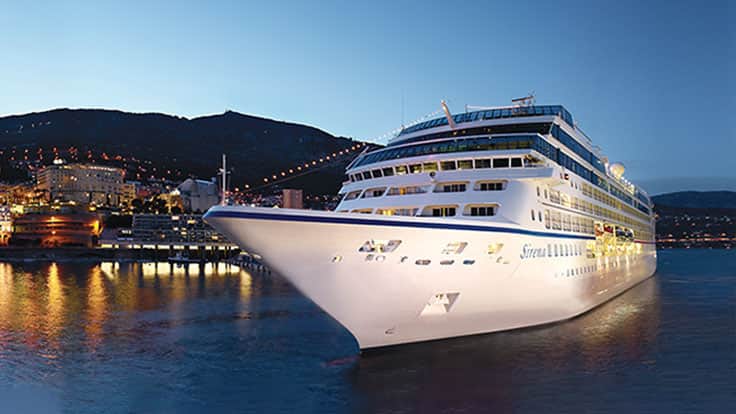 Sirena Cruise Ship at Evening Port A luxurious multi-deck cruise ship illuminated at dusk, moored in a scenic Mediterranean