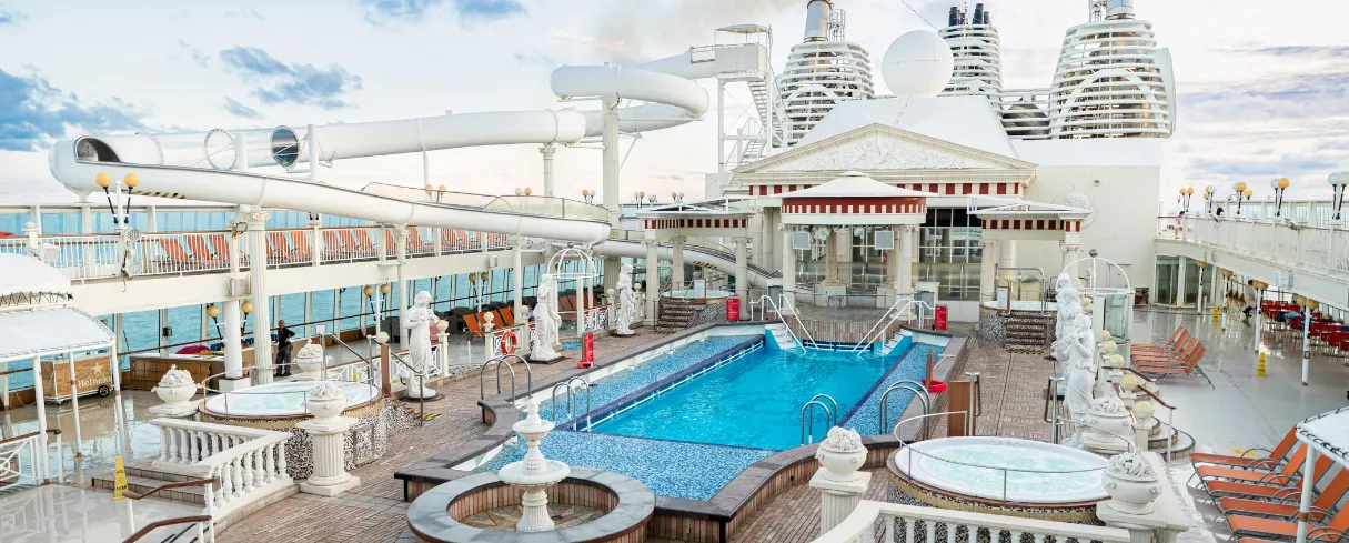 Star Dream Cruises Parthenon Pool Deck An expansive cruise ship pool deck featuring a grand Parthenon-themed architectural structure
