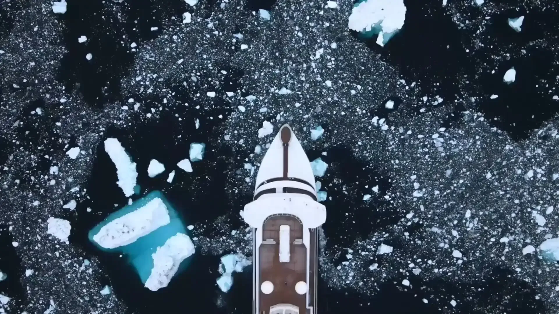 Swan Hellenic Expedition Vessel in Arctic Ice An overhead aerial view of a small expedition cruise ship navigating through Arctic pack ice