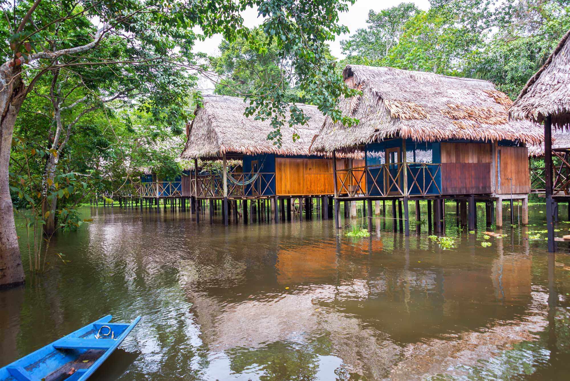 Traditional Stilt Houses in Amazon River, Iquitos A picturesque collection of traditional wooden houses built on stilts over the Amazon River