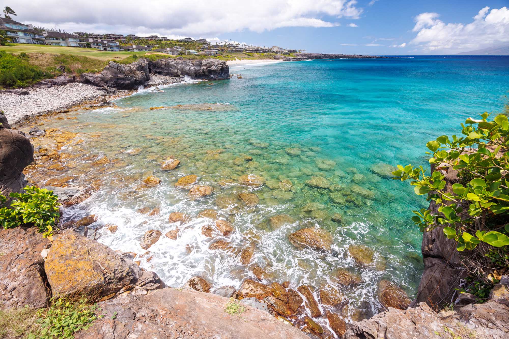 Tropical Coastal Cove in Maui, Hawaii A stunning Hawaiian coastal landscape featuring crystal-clear turquoise waters, rocky outcrops