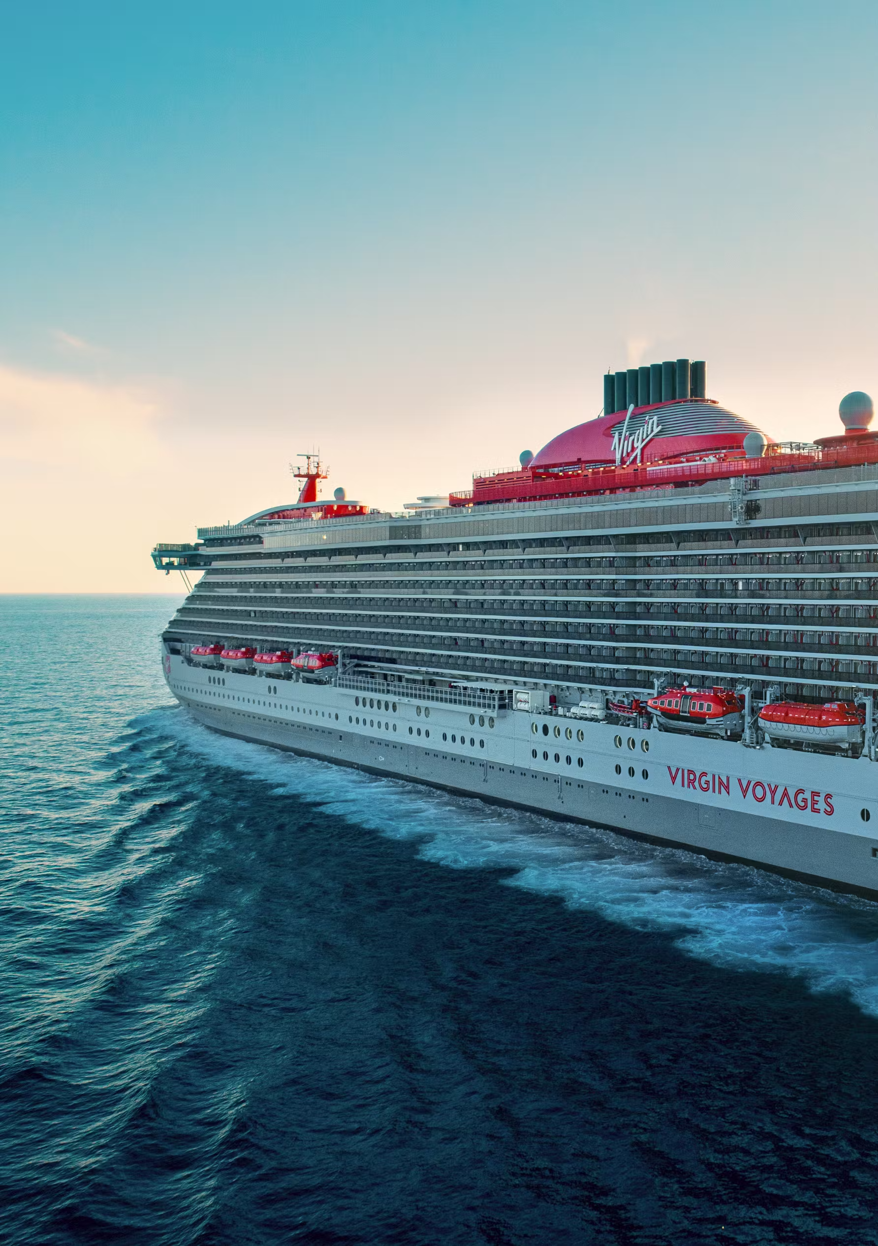 Virgin Voyages Brilliant Lady Cruise Ship at Sea A stunning side profile of the Virgin Voyages Brilliant Lady cruise ship sailing on open turquoise