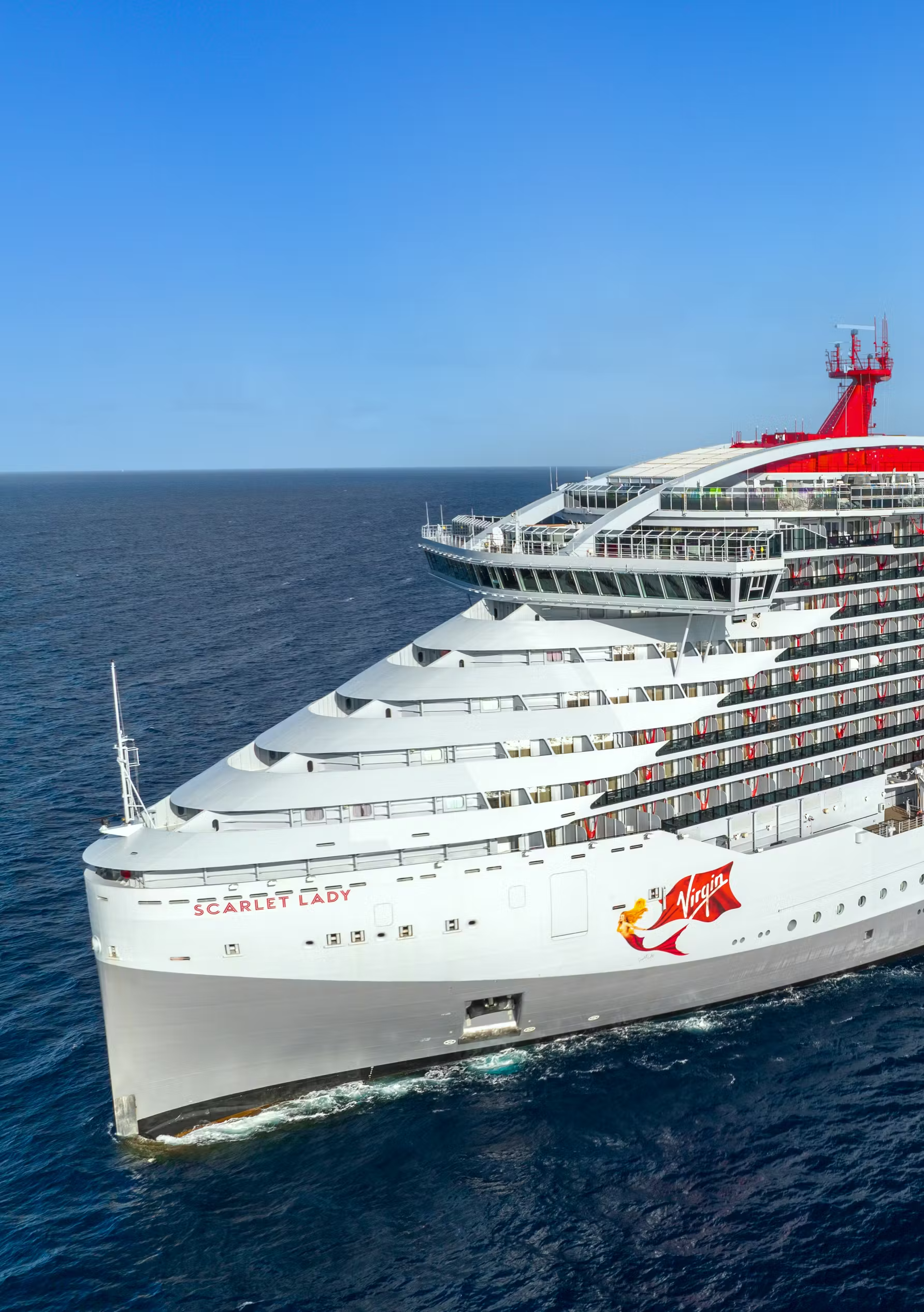 Virgin Voyages Scarlet Lady Cruise Ship at Sea A striking aerial view of the Virgin Voyages Scarlet Lady, a modern cruise ship with distinctive