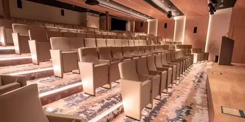 World Explorer Theater Auditorium Seating A modern theater auditorium aboard the Quark Expeditions World Explorer, featuring rows
